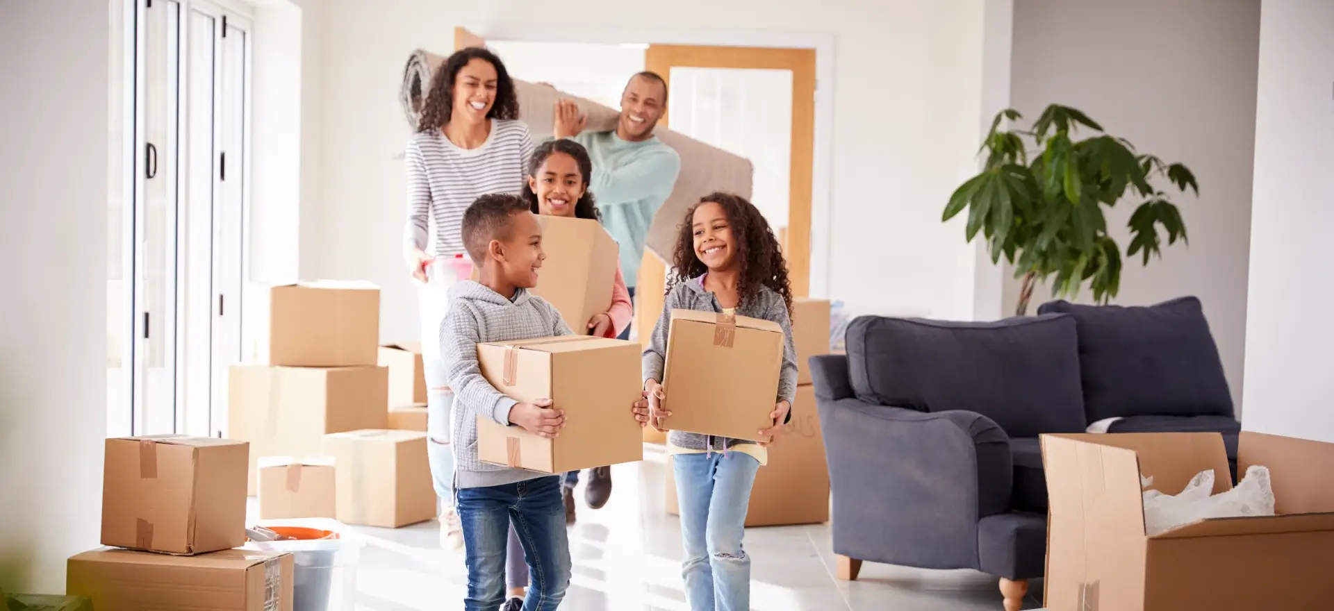 Happy family moving in to their new home thanks to Greenback Capital Mortgage Corporation